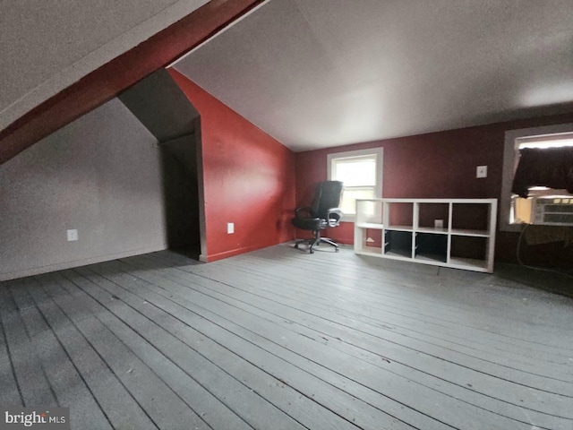 bonus room with hardwood / wood-style flooring, lofted ceiling, and cooling unit