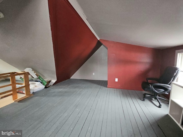 interior space featuring hardwood / wood-style flooring and vaulted ceiling