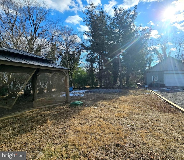 view of yard featuring an outbuilding and a garage