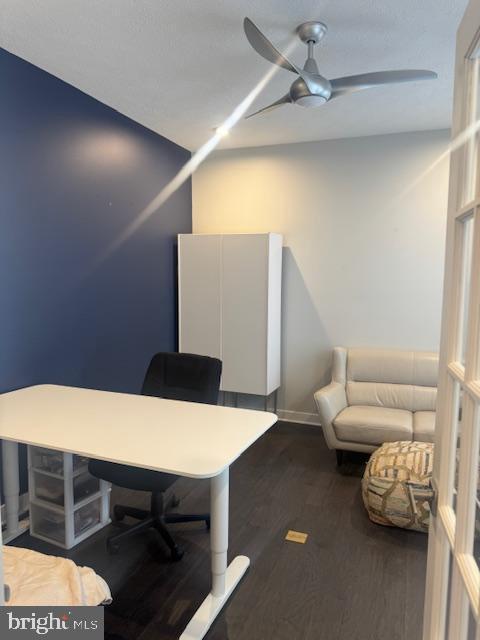 home office featuring ceiling fan and dark hardwood / wood-style floors