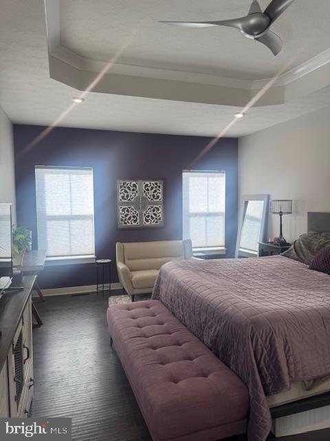 bedroom with dark wood-type flooring and ceiling fan