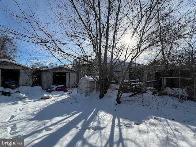 view of snow covered exterior featuring a shed