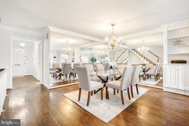 dining space with crown molding, dark hardwood / wood-style floors, and a chandelier