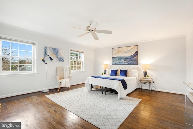 bedroom with dark wood-type flooring, ceiling fan, and crown molding