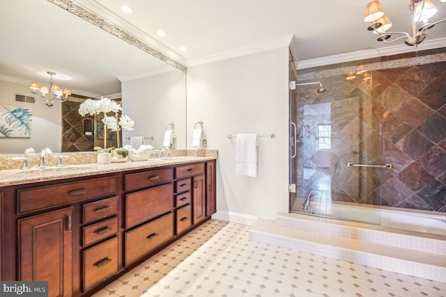 bathroom with crown molding, vanity, a chandelier, and a shower with shower door