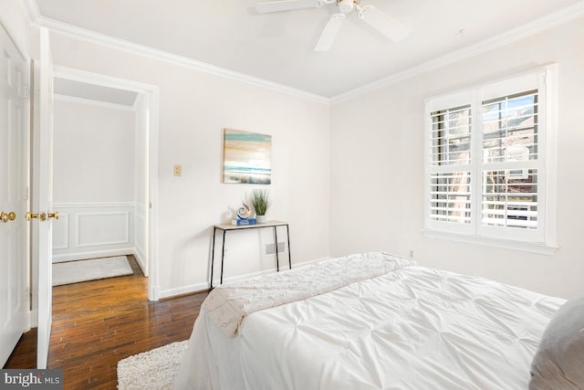 bedroom with ceiling fan, ornamental molding, and dark hardwood / wood-style flooring