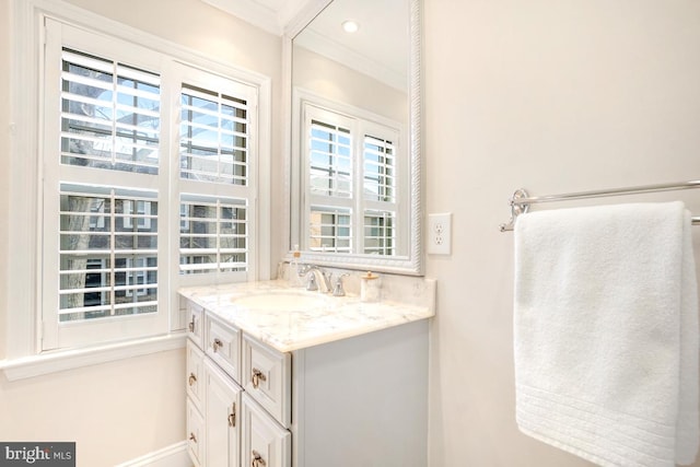 bathroom featuring ornamental molding and vanity