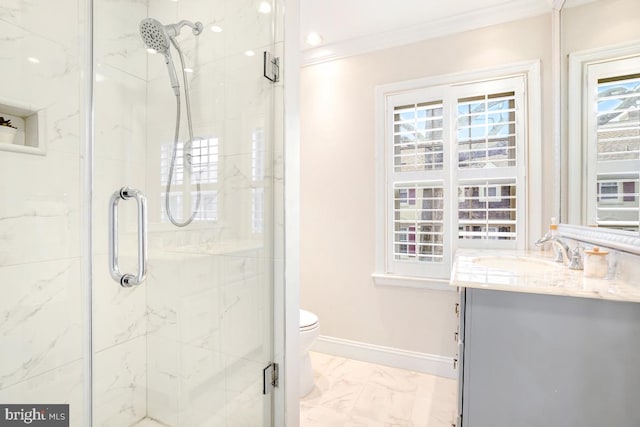 bathroom with crown molding, vanity, toilet, and an enclosed shower