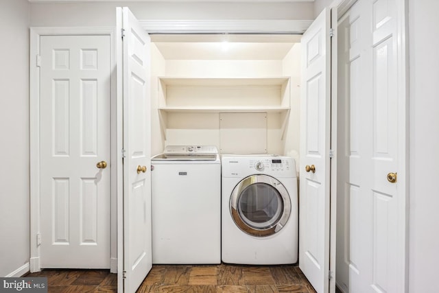 laundry area featuring washer and clothes dryer and dark parquet floors