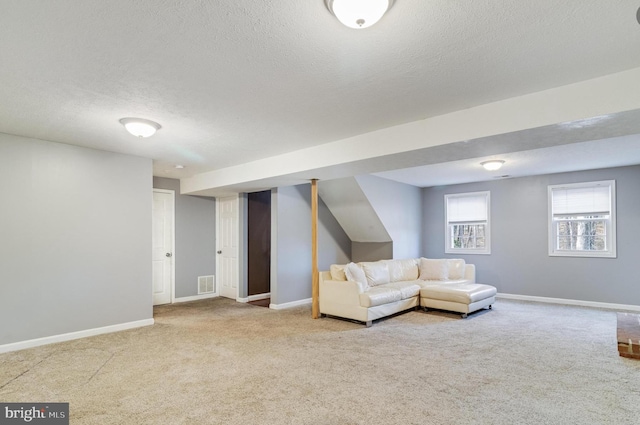 unfurnished living room with a textured ceiling and carpet