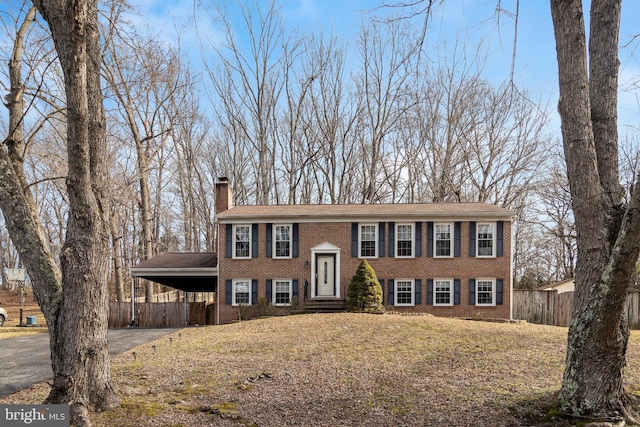 bi-level home featuring a front lawn and a carport