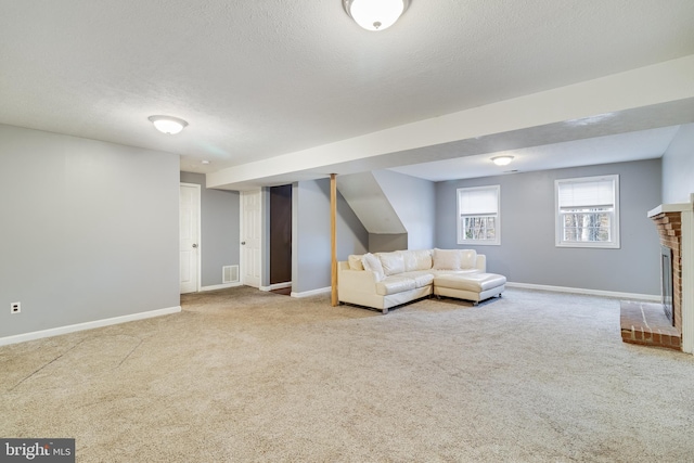 unfurnished living room featuring carpet floors, a textured ceiling, and a fireplace