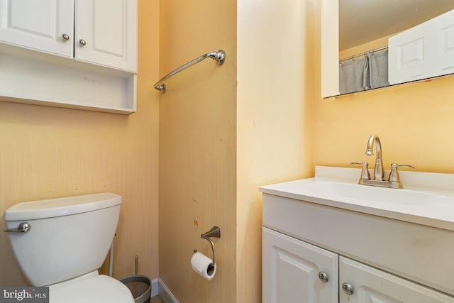 bathroom featuring vanity and toilet