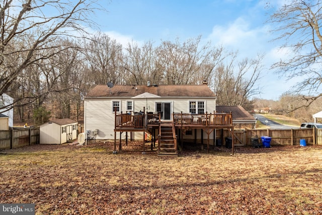 rear view of house featuring a storage shed and a deck