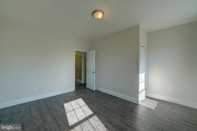 unfurnished room featuring dark hardwood / wood-style flooring