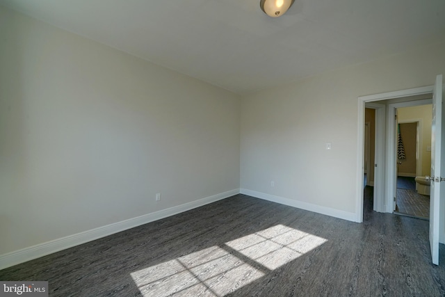 spare room with dark hardwood / wood-style floors