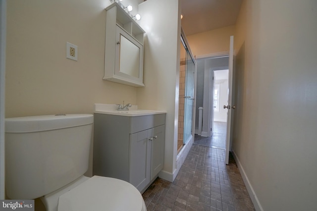 bathroom featuring vanity, toilet, and walk in shower