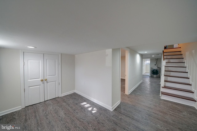 basement with washer / dryer and dark wood-type flooring