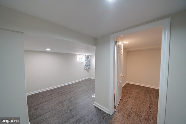 basement with dark hardwood / wood-style flooring