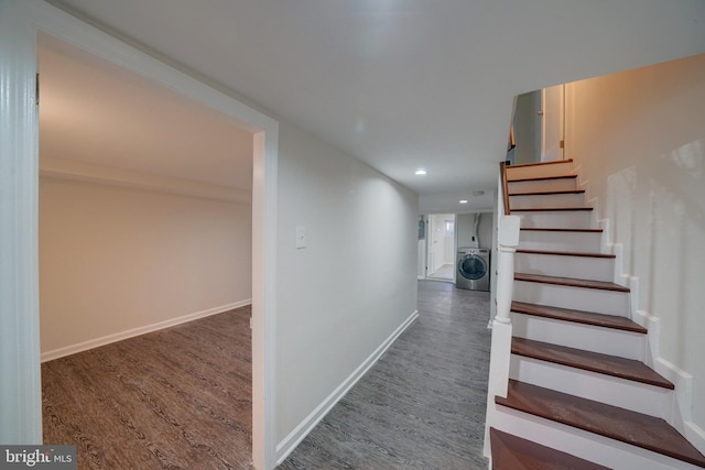 staircase with washer / clothes dryer and hardwood / wood-style flooring