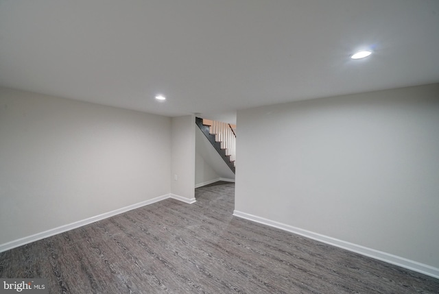 basement with dark hardwood / wood-style flooring