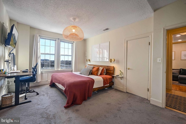 carpeted bedroom featuring a textured ceiling