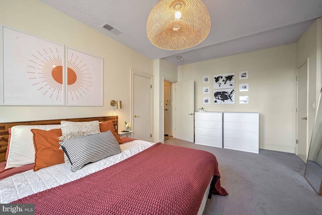 carpeted bedroom with a textured ceiling