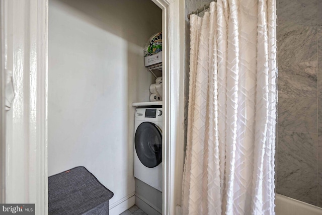 clothes washing area featuring washer / dryer