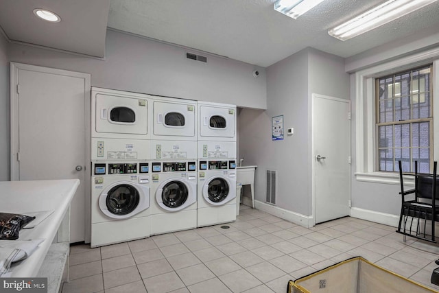 clothes washing area featuring stacked washer / drying machine, separate washer and dryer, a textured ceiling, and light tile patterned floors