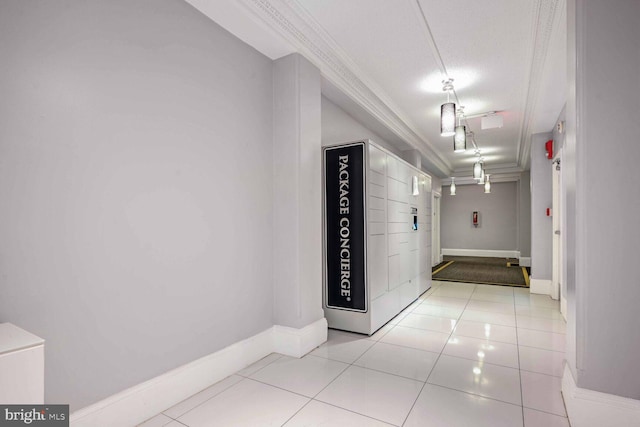 hallway featuring crown molding, a textured ceiling, and light tile patterned floors