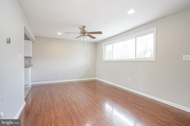 spare room featuring ceiling fan and hardwood / wood-style floors