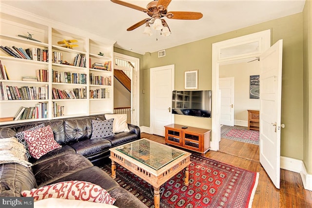 living room with hardwood / wood-style flooring and ceiling fan