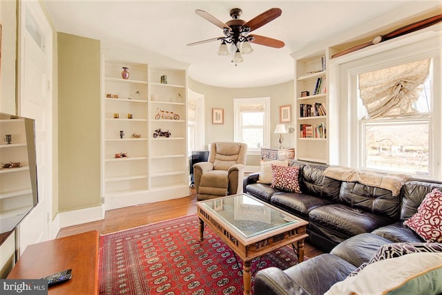 living room with ceiling fan and wood-type flooring