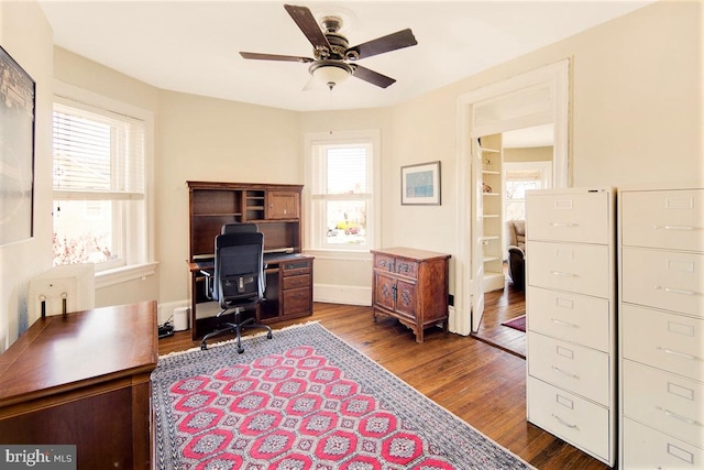 office area featuring dark wood-type flooring and ceiling fan