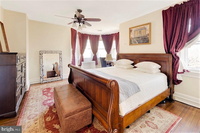 bedroom with ceiling fan and wood-type flooring