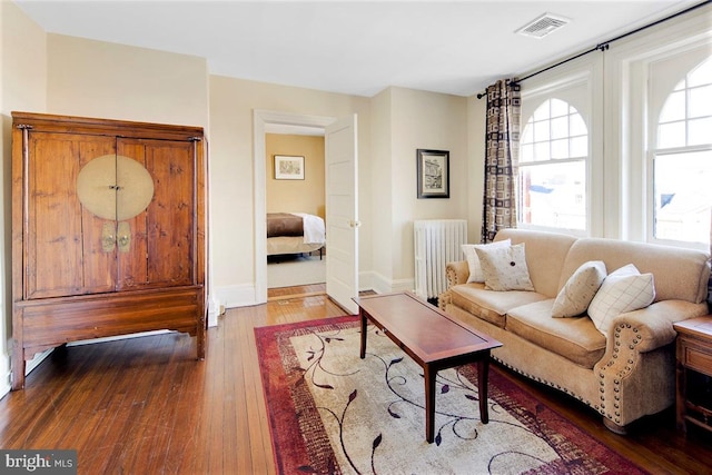 living room with radiator and hardwood / wood-style floors