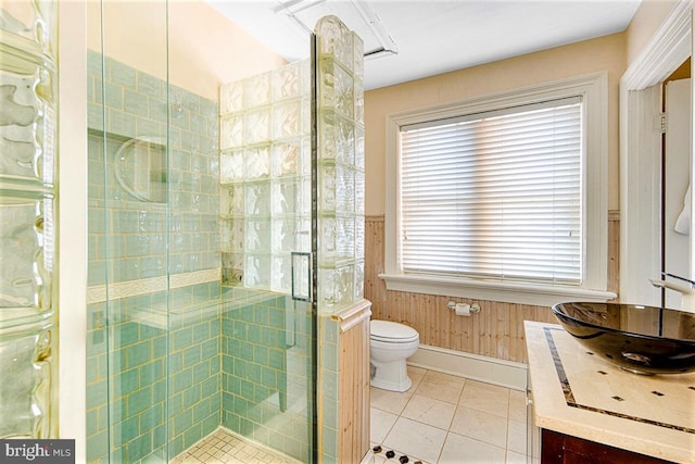 bathroom featuring vanity, tile patterned flooring, toilet, and walk in shower