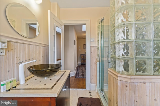 bathroom featuring walk in shower, tile patterned floors, and vanity