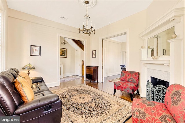 living room with an inviting chandelier and wood-type flooring