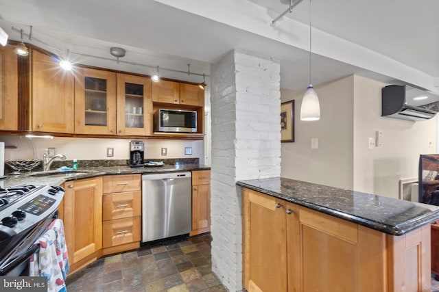 kitchen with stainless steel appliances, dark stone countertops, sink, and a wall mounted AC