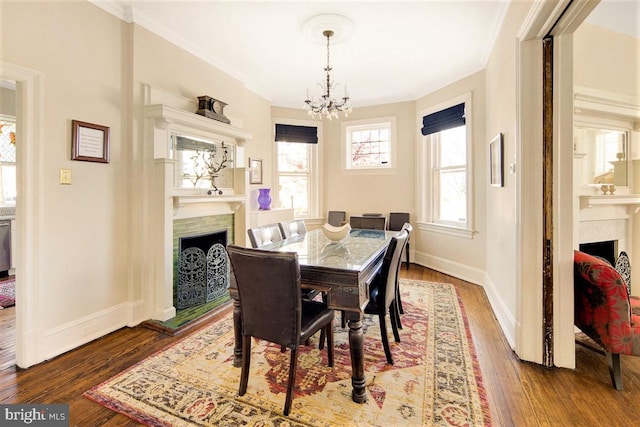 dining room featuring ornamental molding, hardwood / wood-style floors, and a chandelier