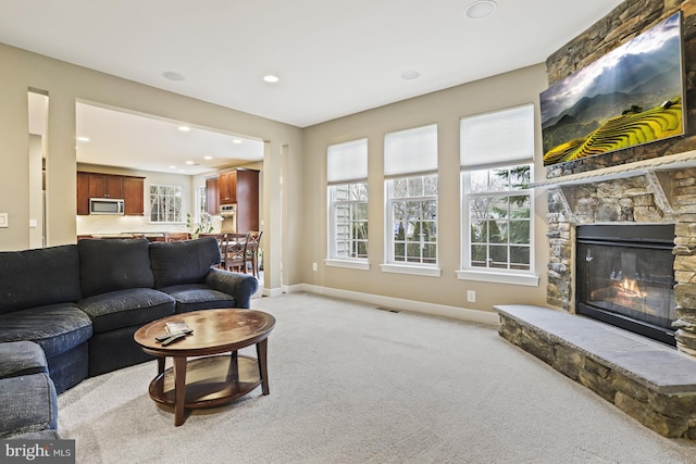 carpeted living room with a fireplace