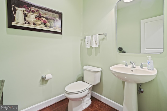 bathroom with sink, hardwood / wood-style flooring, and toilet