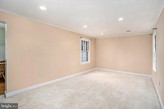 empty room with ornamental molding and light carpet