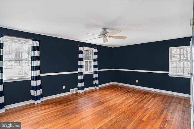 spare room featuring hardwood / wood-style flooring and ceiling fan