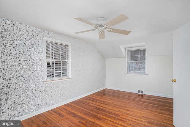 bonus room with dark wood-type flooring, ceiling fan, and vaulted ceiling