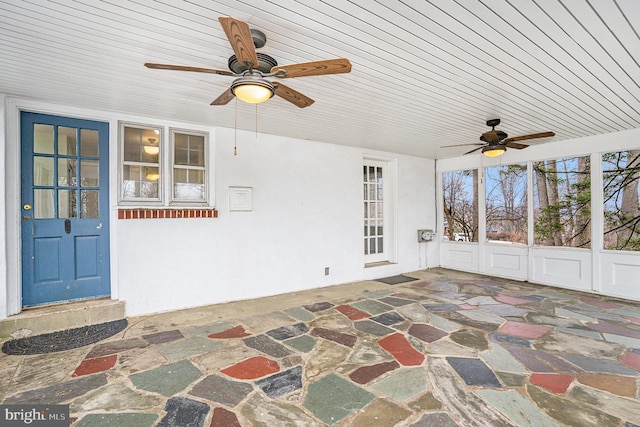 sunroom / solarium with ceiling fan and wood ceiling