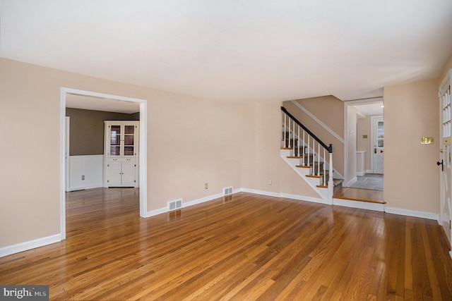 unfurnished living room with wood-type flooring