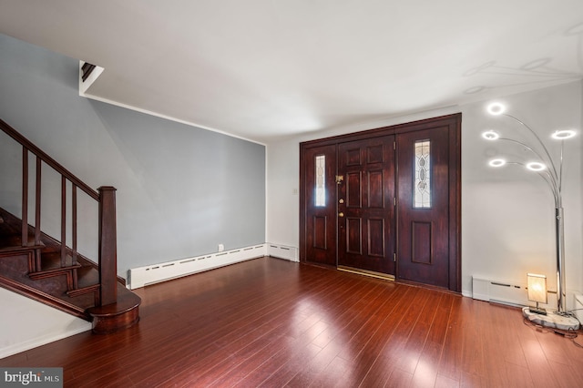 foyer with hardwood / wood-style floors and a baseboard heating unit