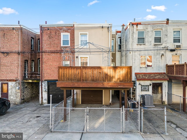 rear view of property with central AC unit